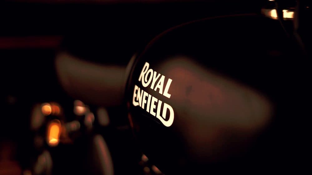 A Royal Enfield fuel tank in low evening light