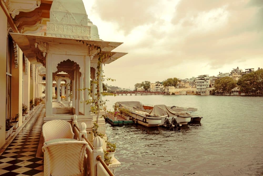 Boats moored below a lakeside palace terrace